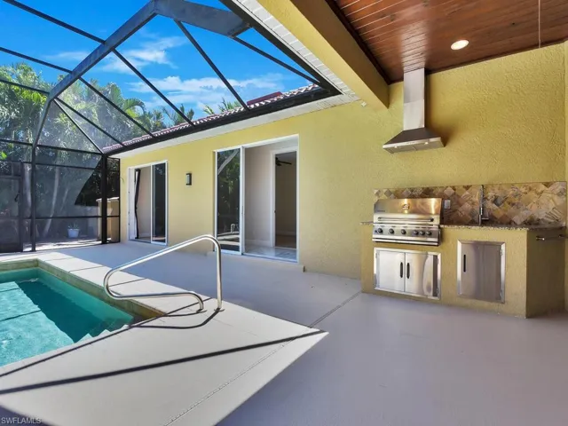 Swimming pool with a patio and a lanai