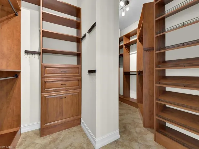 Walk in closet with light tile patterned flooring