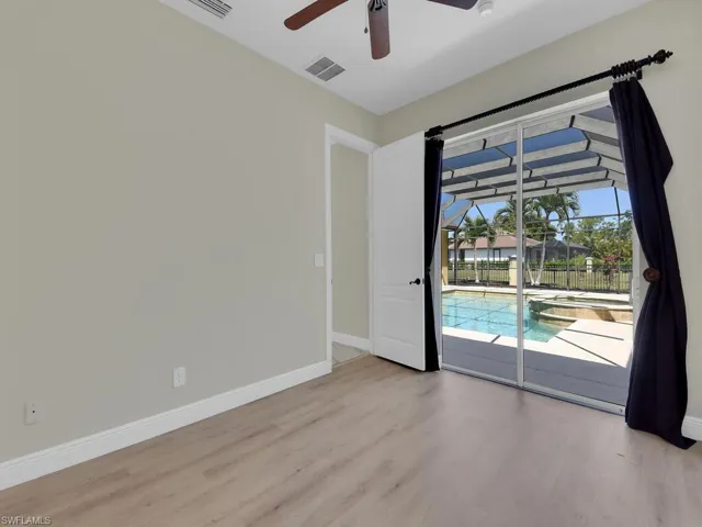 Empty room featuring ceiling fan, wood finished floors, and baseboards