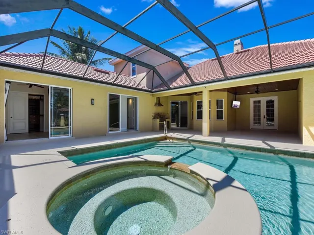 View of pool featuring a ceiling fan, a patio area, french doors, and a pool with connected hot tub