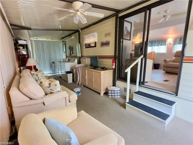 Sunroom featuring a ceiling fan, an outdoor living space, and separate washer and dryer