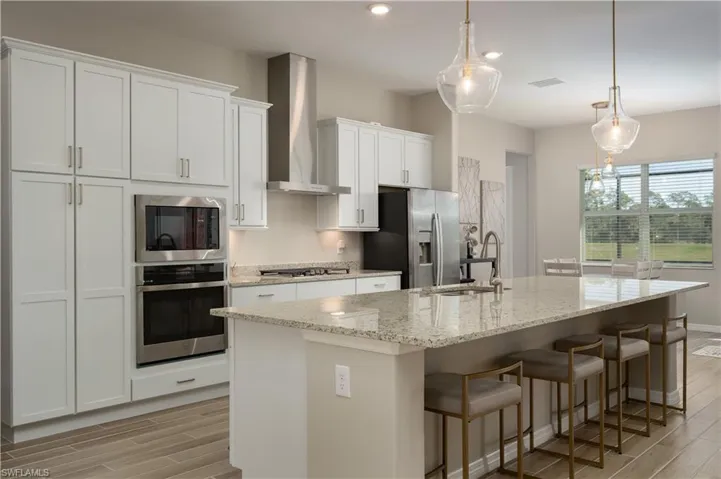 Large, oversized kitchen with generously sized island with seating for 4. Island has a sink and dishwasher built in to it.