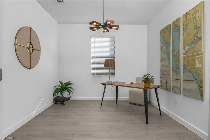 Den/Flex room located just off foyer entry, features custom lighting/ fan. (photo is from staged home in community)
