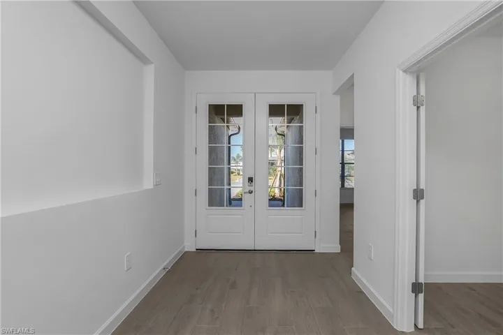 Foyer entrance with french doors and wood finished floors
