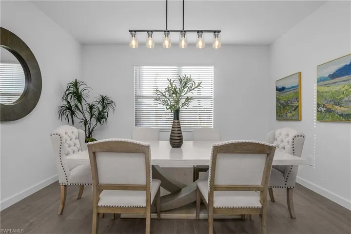 Open family dining room is perfect for entertaining guests and features upgraded custom lighting. (photo is from staged home in community)