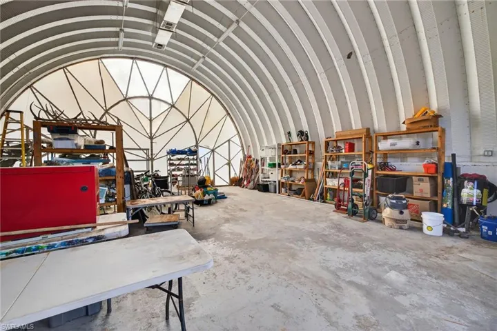 Miscellaneous room featuring a barrel ceiling and a garage