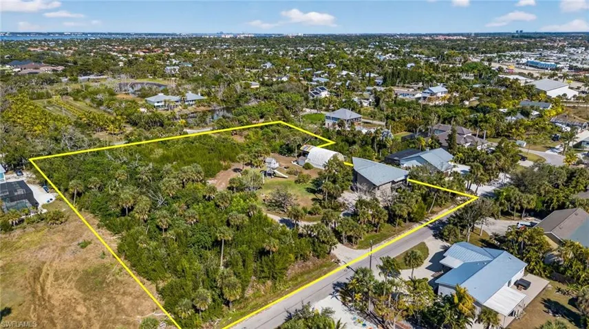 Aerial view of residential area featuring property boundaries highlighted