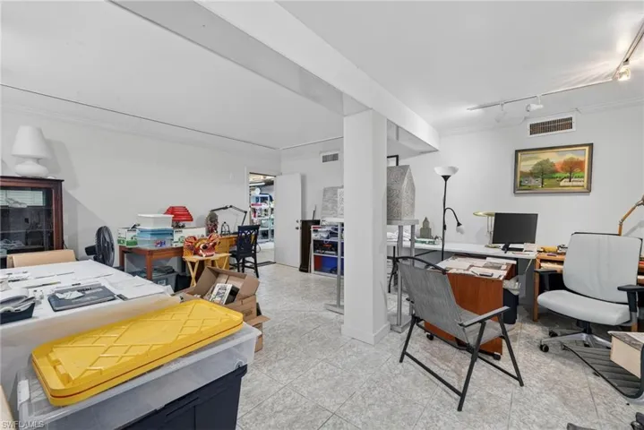 Home office featuring crown molding and rail lighting
