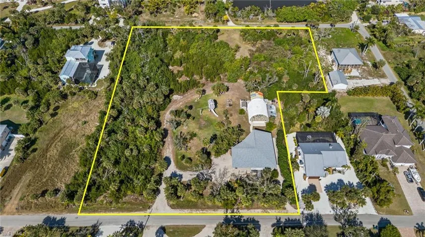 Aerial view of residential area featuring property boundaries highlighted