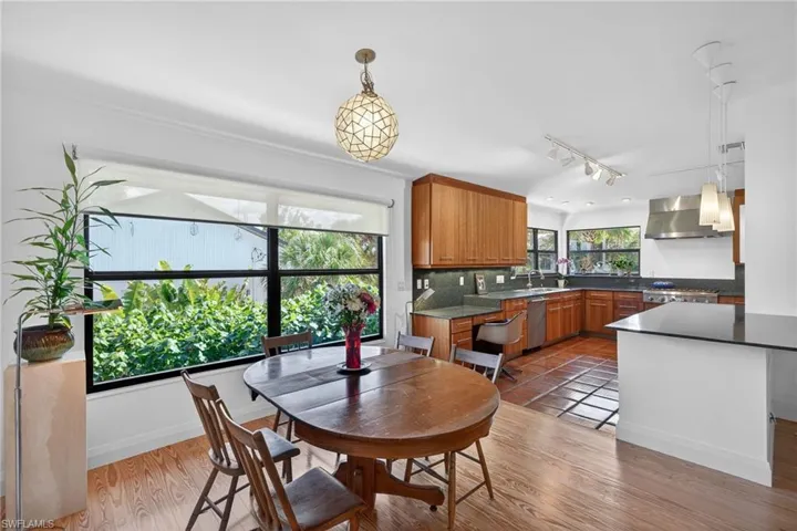 Dining space featuring rail lighting and light wood finished floors