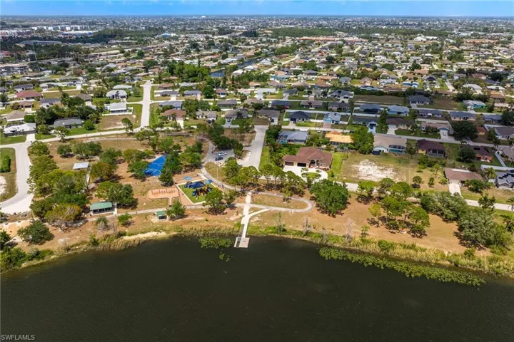 Birds eye view of property with a water view and a residential view