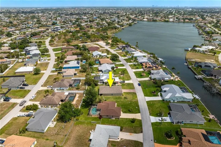 Drone / aerial view with a water view and a residential view