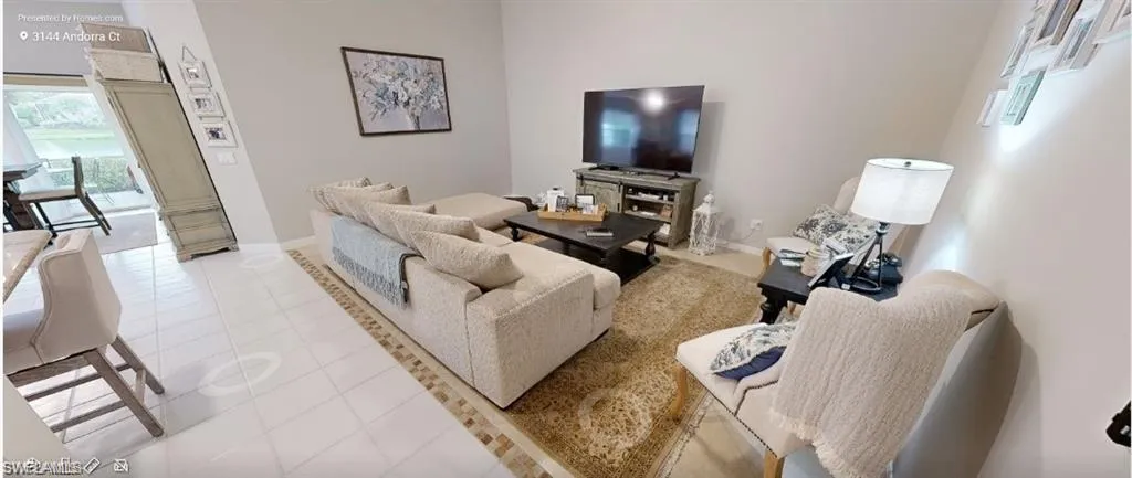 Living area with light tile patterned floors and baseboards