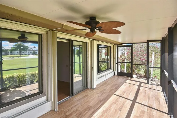 Unfurnished sunroom featuring a ceiling fan
