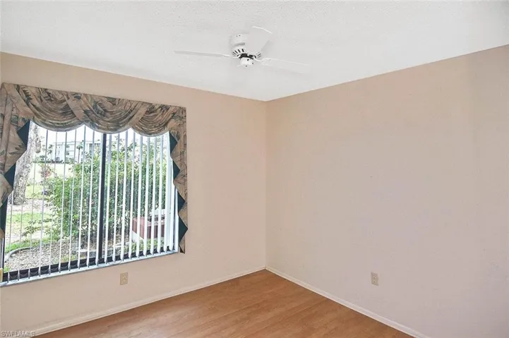 Unfurnished room with wood finished floors and ceiling fan