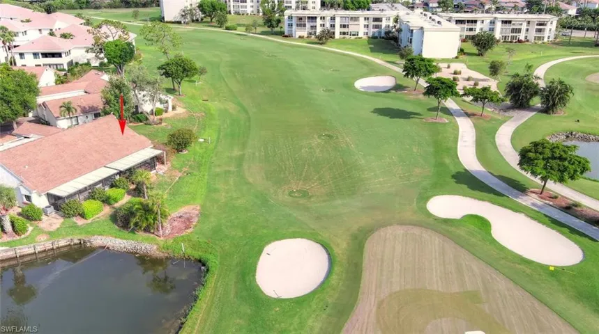 Drone / aerial view of a large body of water and a golf course