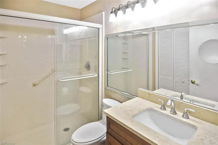 Full bathroom featuring a stall shower and vanity