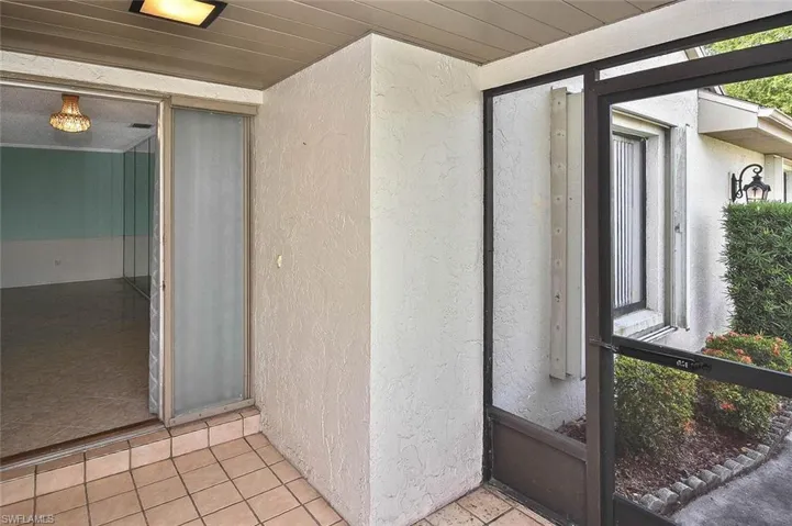 Entrance to property featuring stucco siding