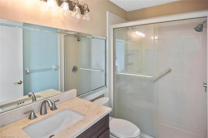 Full bathroom featuring a shower stall and vanity