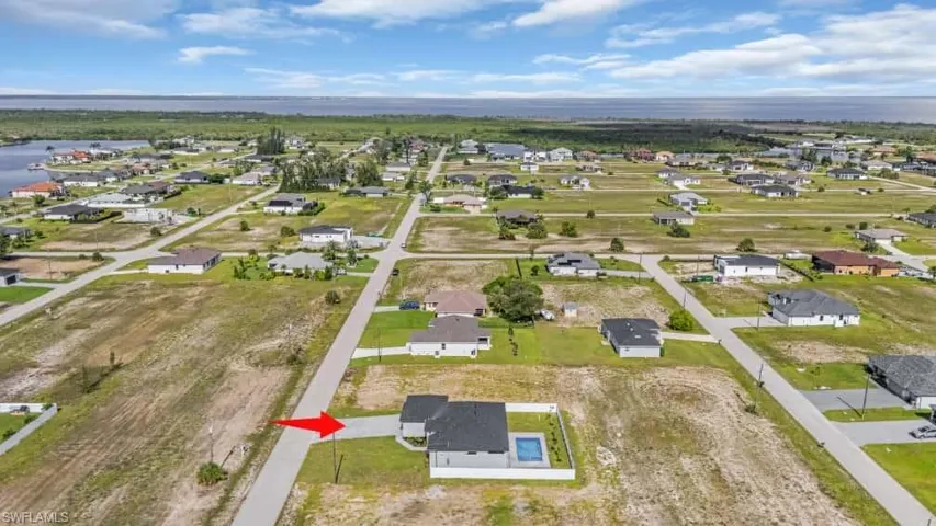 Aerial overview of property's location with a large body of water and nearby suburban area