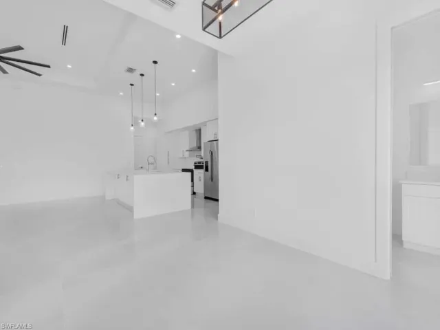 Unfurnished living room featuring ceiling fan and recessed lighting