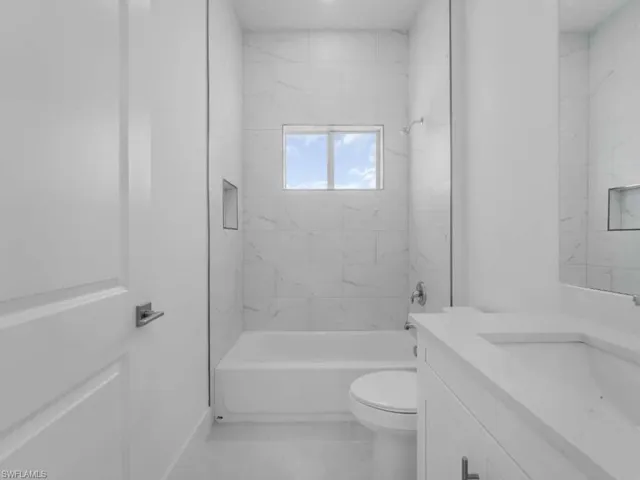 Full bath featuring vanity and shower / tub combination