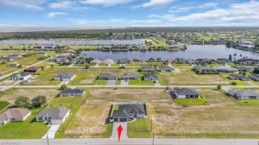 Aerial perspective of suburban area with a nearby body of water