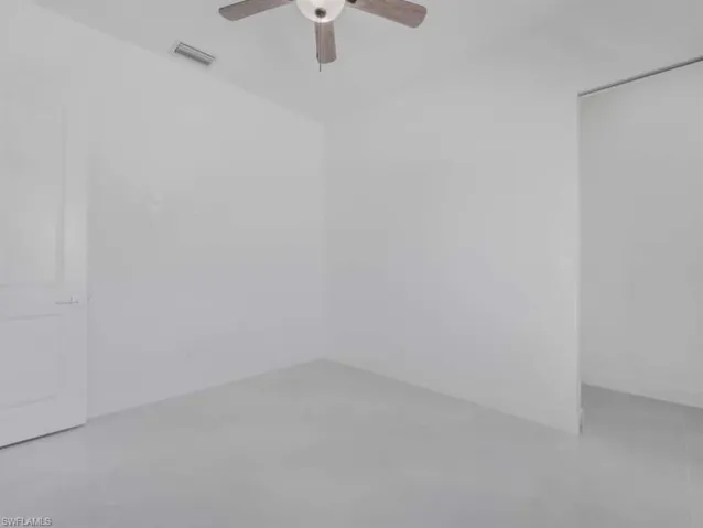 Empty room featuring a ceiling fan