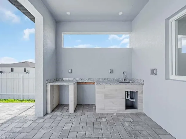 View of patio / terrace with area for grilling and a sink