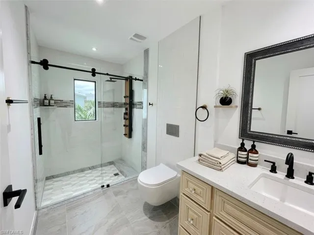 Bathroom with vanity and a stall shower