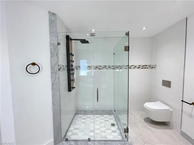 Full bathroom with a stall shower and recessed lighting