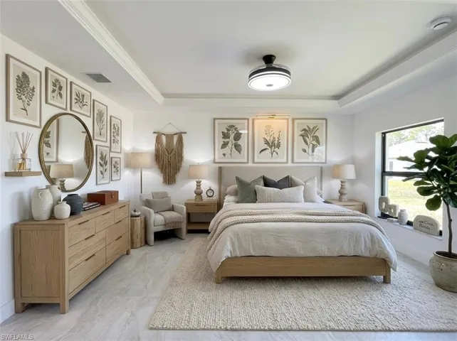 Bedroom with a tray ceiling and crown molding