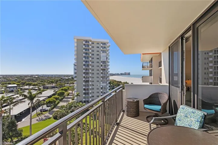 Balcony featuring a water view and a city view