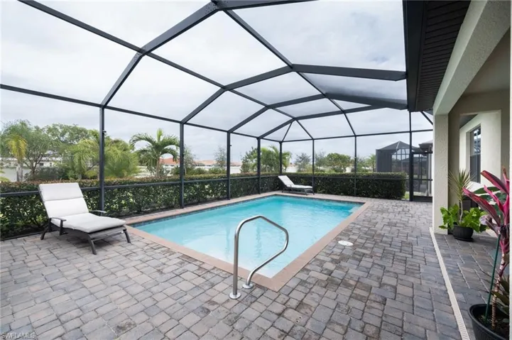 View of pool featuring screen enclosure