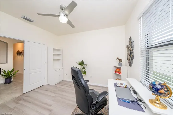 Den/Office space with ceiling fan and light hardwood / wood-style floors