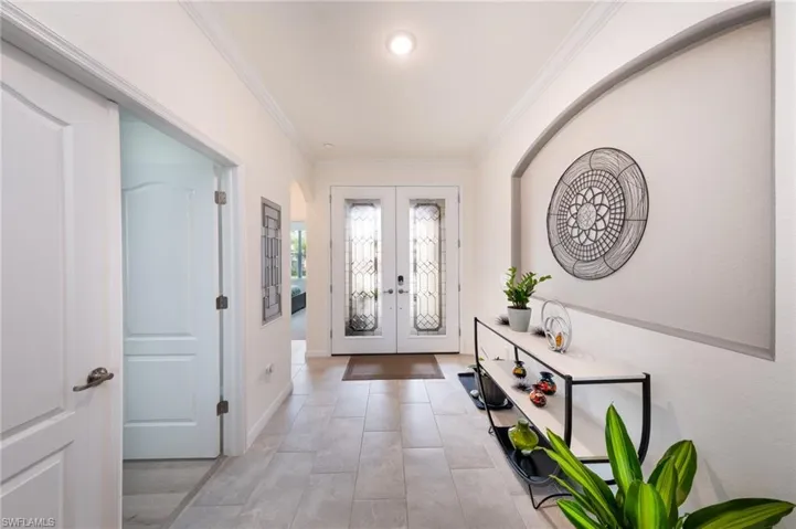 Entryway with French doors and crown molding