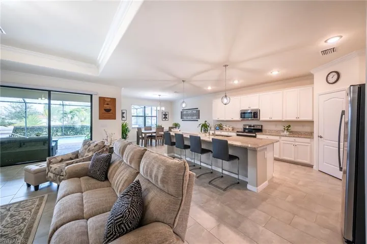 Tiled living room with sink and ornamental crown molding