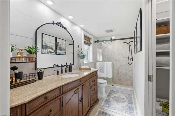 Full bathroom with vanity, a shower stall, and recessed lighting