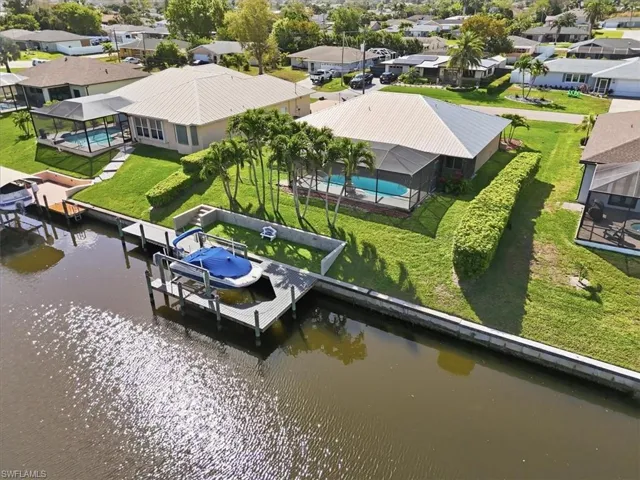 Aerial view of residential area featuring a nearby body of water
