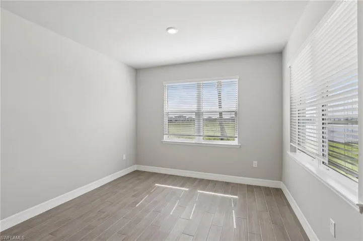 Empty room with wood finished floors and baseboards