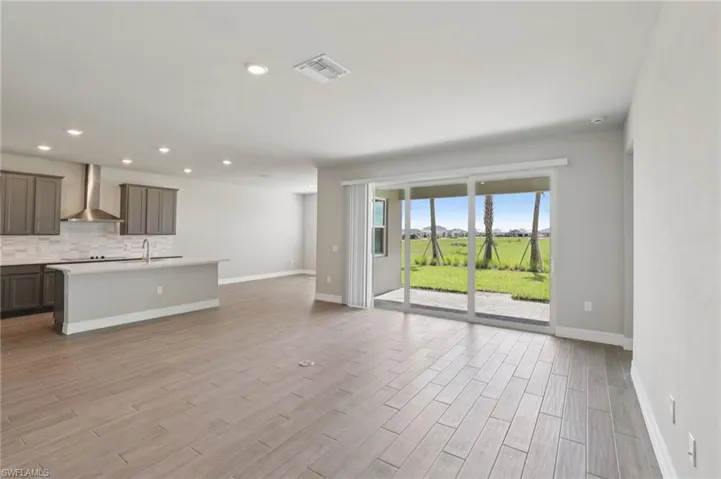 Unfurnished living room with light wood finished floors and recessed lighting