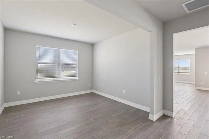 Empty room featuring wood finished floors and baseboards