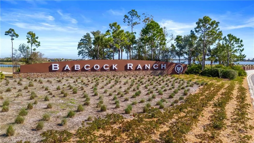 Community / neighborhood sign with a water view