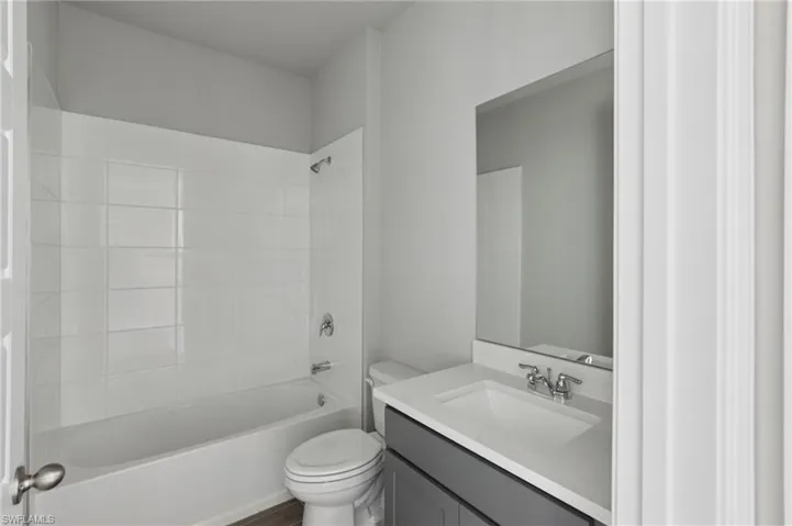 Bathroom featuring vanity and shower / bathtub combination