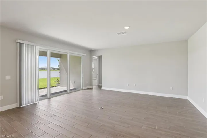 Unfurnished room with wood finished floors and a water view