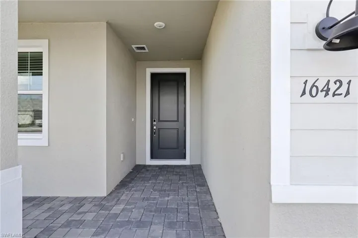 View of exterior entry with stucco siding