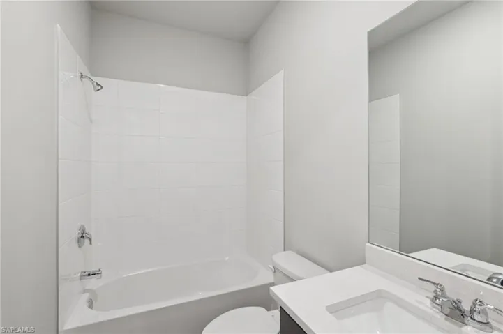 Full bath featuring vanity and bathing tub / shower combination