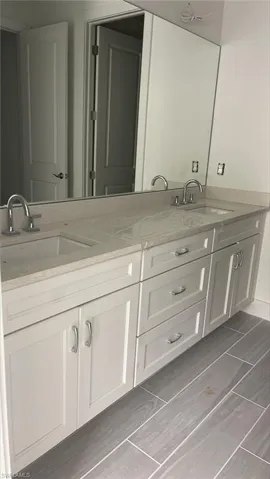 Primary bathroom with quartz countertops and soft-close cabinets and drawers
