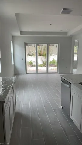 Standing in kitchen with view out to backyard