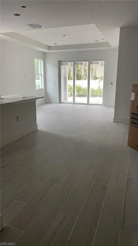 Standing in foyer with great room tray ceiling pictured